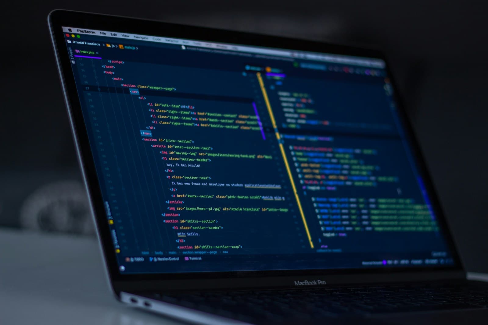 Developer workspace with code visible on a laptop screen